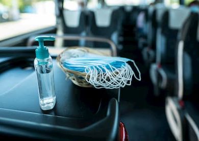 Hand sanitizer and masks at front of bus